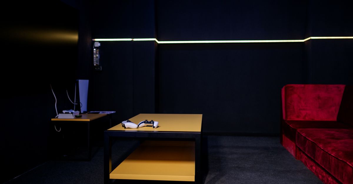 A sleek gaming room featuring controllers and vibrant furniture, ideal for entertainment enthusiasts.
