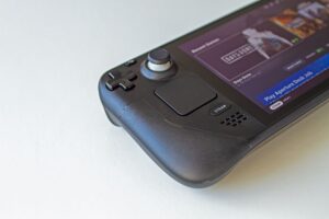Handheld gaming console with retro game selection on screen