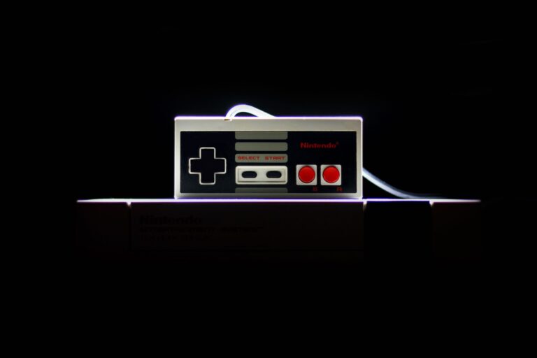 Classic NES controller with dramatic lighting on a black background, evoking retro gaming nostalgia