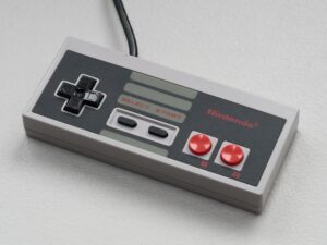 Vintage Nintendo controller photographed from above on a white background, the classic N64 controller for retro gaming emulation
