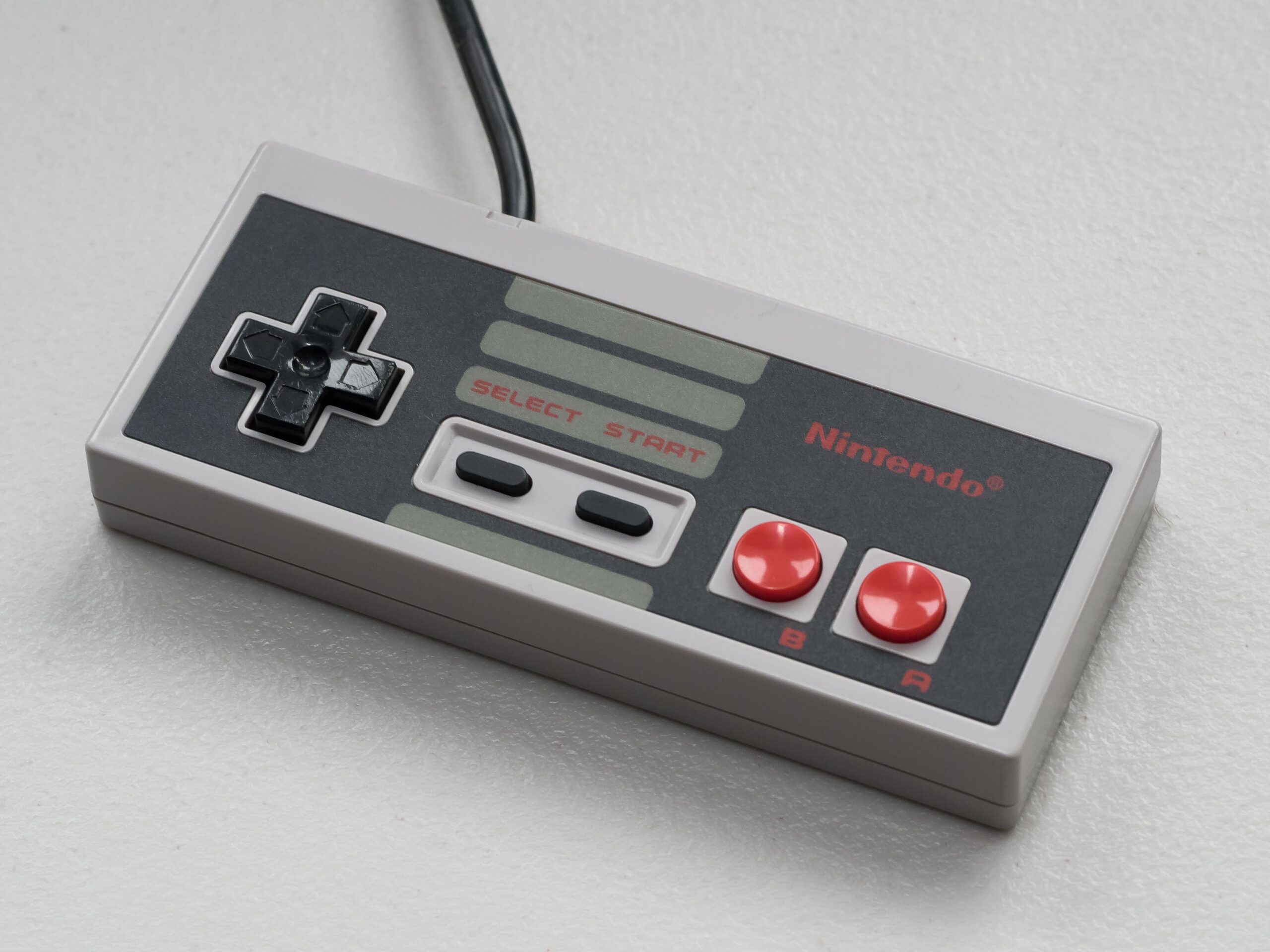 Vintage Nintendo controller photographed from above on a white background, the classic N64 controller for retro gaming emulation