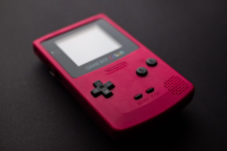 Red Nintendo Game Boy handheld console on a clean background, classic retro gaming on a budget
