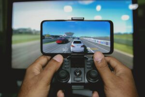 Close-up of hands playing retro games on an iPhone with a wireless controller