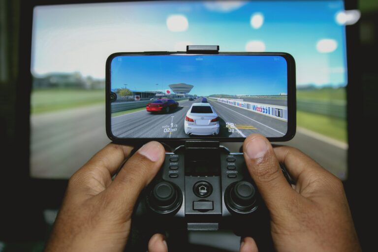 Close-up of hands playing retro games on an iPhone with a wireless controller
