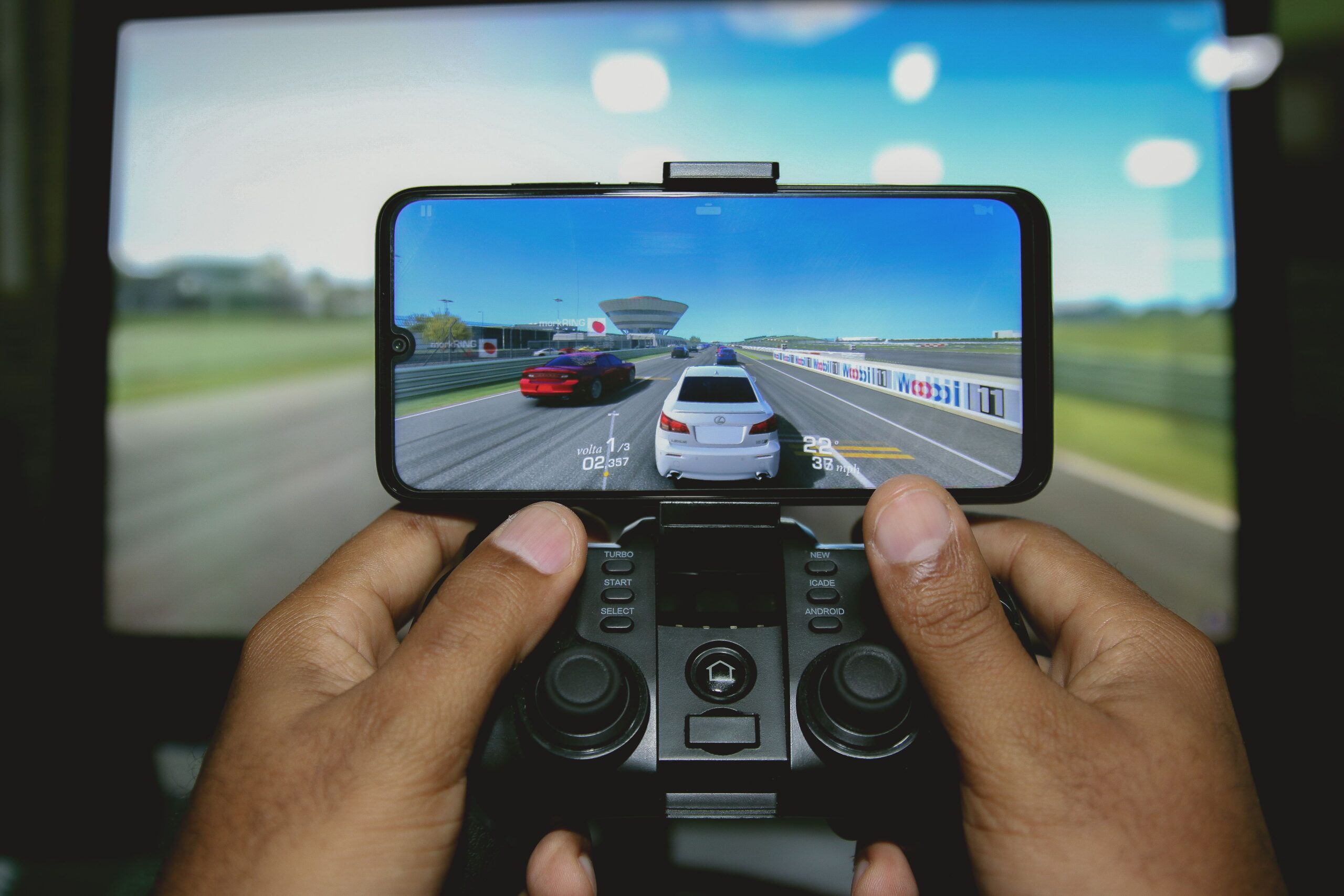 Close-up of hands playing retro games on an iPhone with a wireless controller