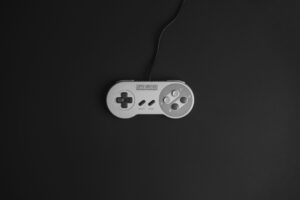 A Super Nintendo controller on a black background, the perfect image for a guide to the best SNES games of all time.