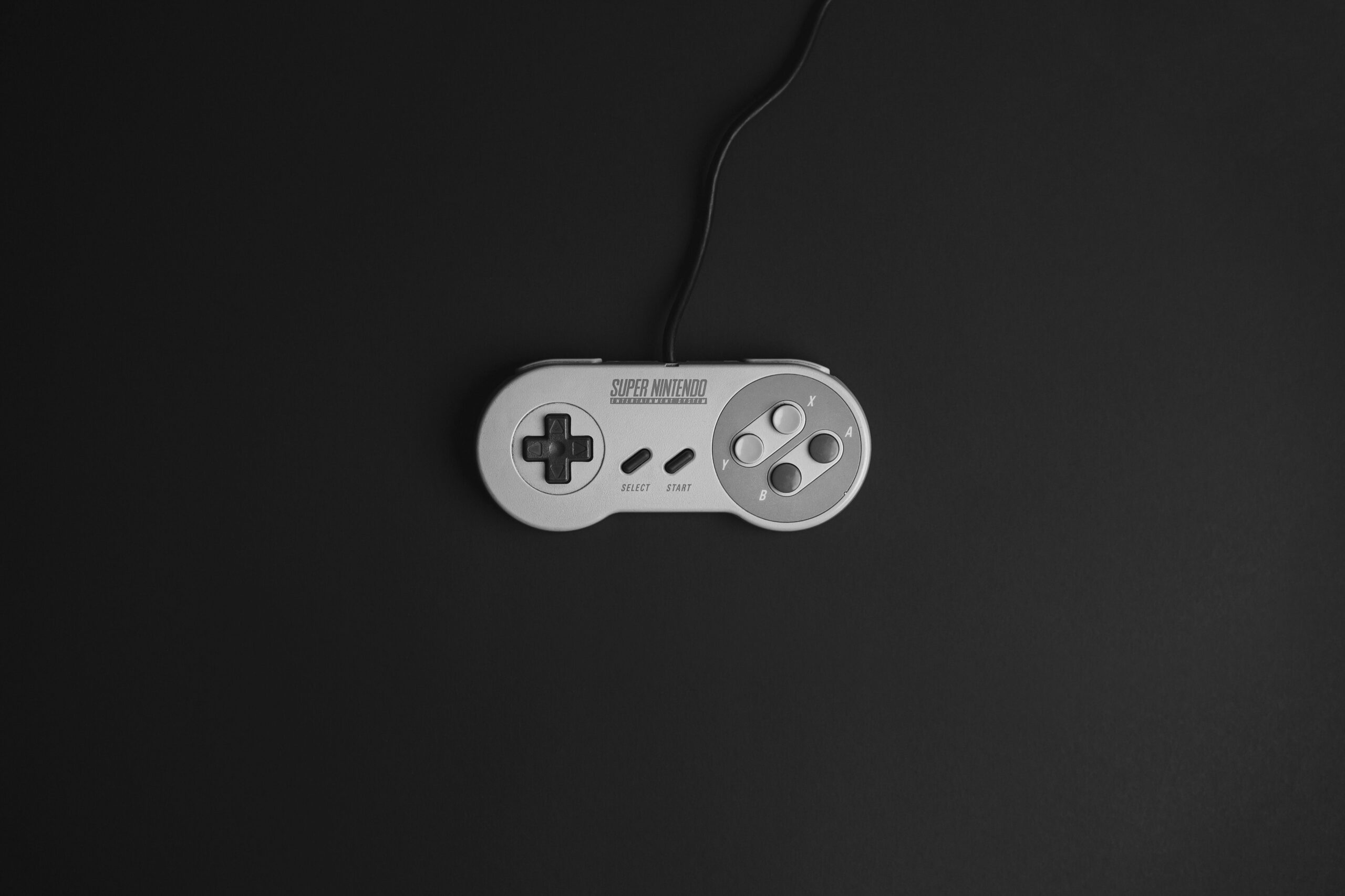 A Super Nintendo controller on a black background, the perfect image for a guide to the best SNES games of all time.